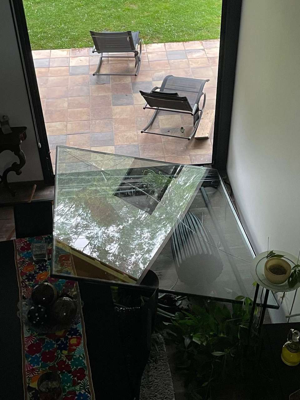 El ventanal roto por los asaltantes, visto desde el interior de la vivienda.